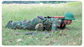A soldier lying on the ground

Description automatically generated